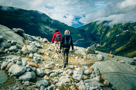 Young Couple Made it to the Top. Shot taken in Swiss Alps, near Rhone Glacier and Furka Pass.