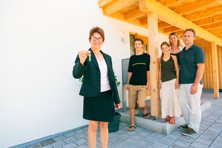 Realtor With Happy New Home Ownersの写真素材