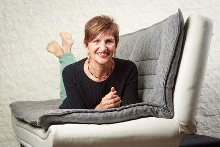 Senior Woman Sitting On Couchの写真素材