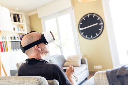Adult Man Using Vr Goggles At Home