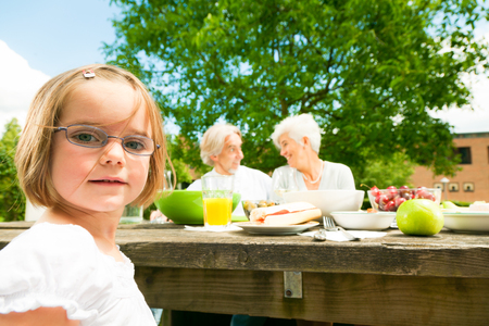 Little Girl And Her Grandparents Are Having A Picnicの写真素材