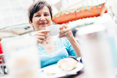 Senior Woman Enjoying A Cup Of Coffee, Tuebingen, Germanyの写真素材