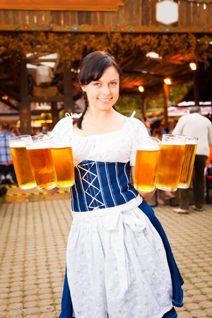 Young German Woman Serving Beerの写真素材