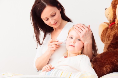 Mother Checking Her Daughters Temperatureの写真素材