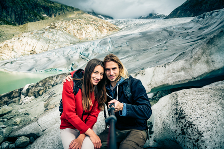 Young Couple Hiking In The Swiss Alps, Taking A Selfieの写真素材