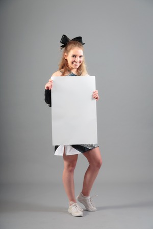 Young Cheerleader On Gray Backgroundの写真素材