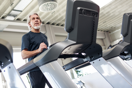 Senior Caucasian Man Working Out At The Gym