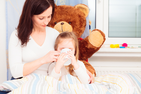 Mother Giving Her Ill Daughter Hot Teaの写真素材