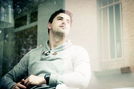 Young Man Sitting At The Windowの写真素材
