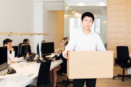 Young Employee Has Been Fired And Is Leaving Officeの写真素材