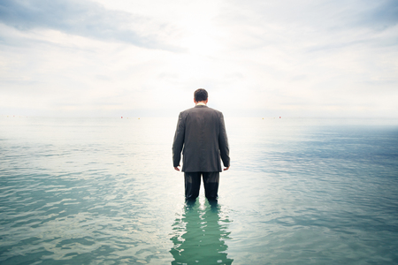Businessman Knee-deep In Waterの写真素材