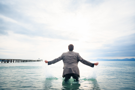 Businessman Knee-deep In Waterの写真素材