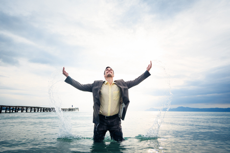 Businessman Knee-deep In Waterの写真素材