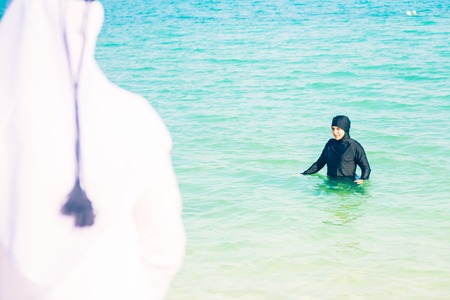 Young Woman In Burkini Swimming In The Seaの写真素材