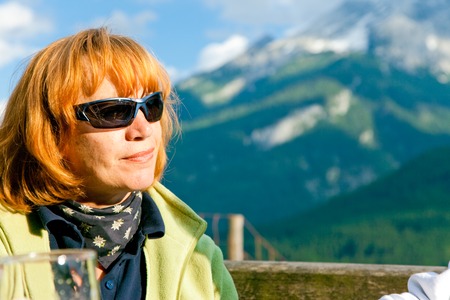 Senior Sitting In An Alpine Restaurantの写真素材