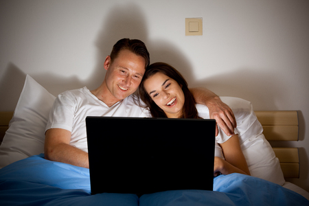 Happy Couple Watching A Videoの写真素材