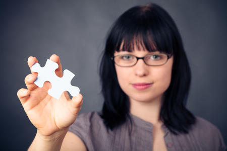 Young Woman With Puzzle Pieceの写真素材