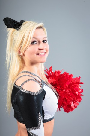Young Cheerleader On Gray Backgroundの写真素材