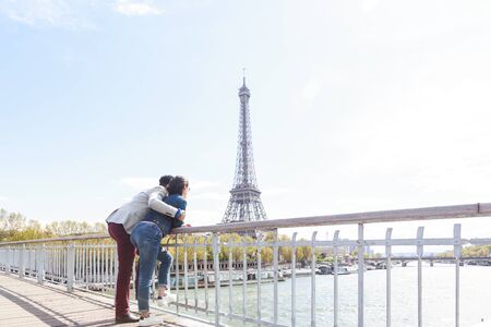 Multi-ethnic Couple Having Fun In Paris Near Eiffel Towerの写真素材