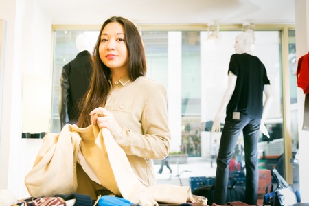 Young Asian Woman Shopping For Clothesの写真素材