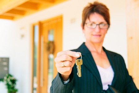 Realtor Giving You The Key To Your New Homeの写真素材