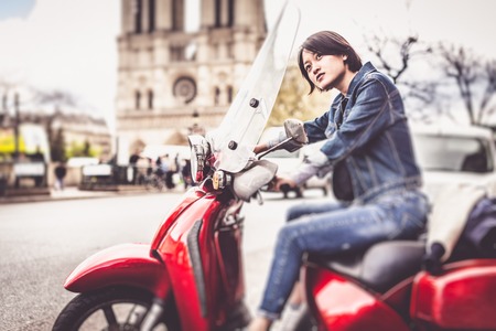 Young Chinese Female On Scooter In Parisの写真素材