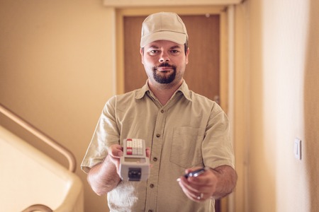 Messenger Delivering A Parcel, Asking For Your Signatureの写真素材