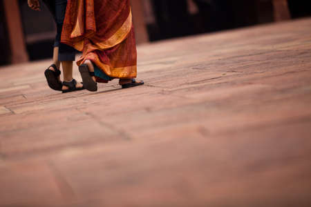 Two Ladies Walking On A Sandstone Floorの写真素材
