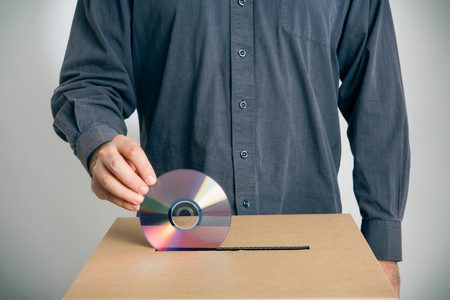 guy putting a cd into a ballot box: electronic voting, the wrong way.の写真素材