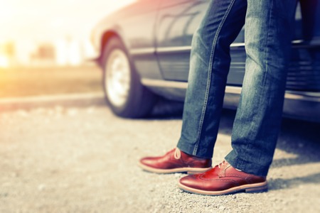Man Standing Next To Convertible Classic Carの写真素材
