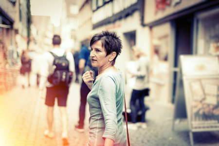 Senior Woman Walking Through The Streets Of T?bingen, Germanyの写真素材