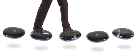 Businessman On Stepping Stonesの写真素材