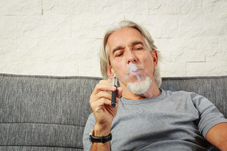 Senior Vaping, Enjoying An Electronic Cigaretteの写真素材