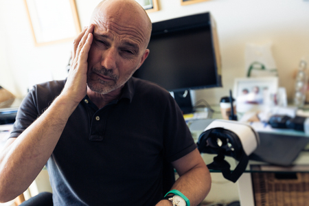 Adult Man Suffering From Cyber Sicknessの写真素材