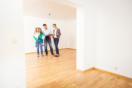 Family Discussing With Their Interior Designerの写真素材