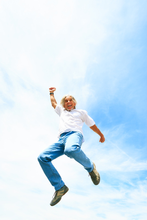 Man In His 50s Jumping Highの写真素材