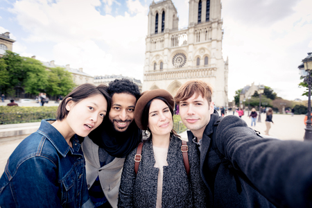 Multi-ethnic Group Of Friends Having Fun In Paris, Notre Dameの写真素材