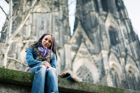 Young Woman In Front Of Colognes Cathedralの写真素材