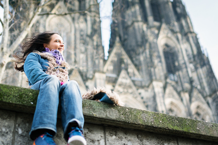 Young Woman In Front Of Colognes Cathedralの写真素材