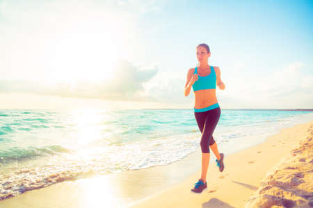 Young Woman Jogging On The Beachの写真素材