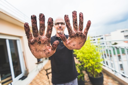 Adult Man Working In His Garden, Getting His Hands Dirtyの写真素材