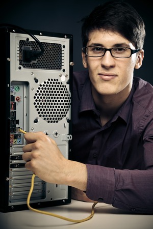 Young Man Connecting Network Cableの写真素材