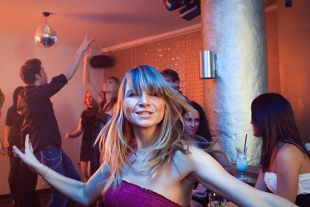 Pretty Blond Woman Dancing In A Nightclubの写真素材