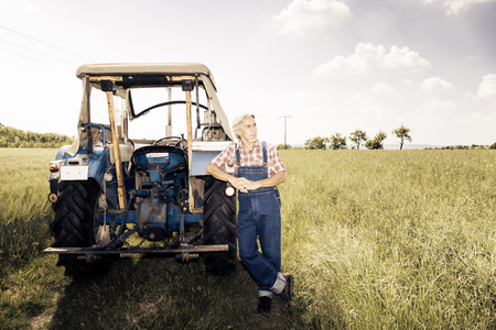 Farmer Standing In A Fieldの写真素材