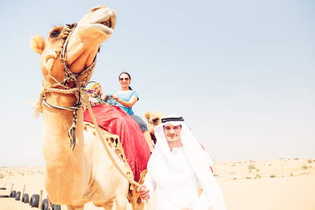 Arabian Man And Tourist Riding A Camelの写真素材
