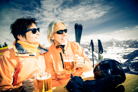 Skiing Senior Couple Having A Breakの写真素材