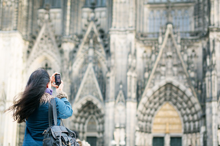 Young Woman In Front Of Colognes Cathedralの写真素材
