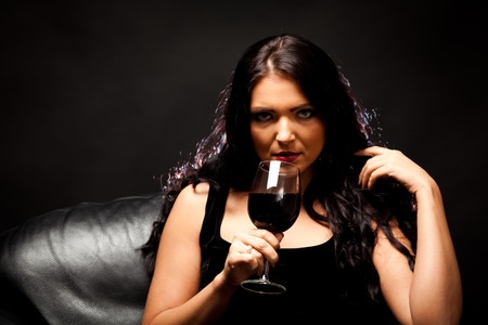 Young Woman Enjoying A Glass Of Wineの写真素材