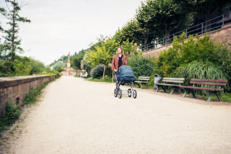 Young Father With Baby Stroller In The Parkの写真素材