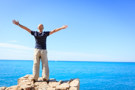 Adult Man Enjoying A Moment Of Freedom By The Seaの写真素材